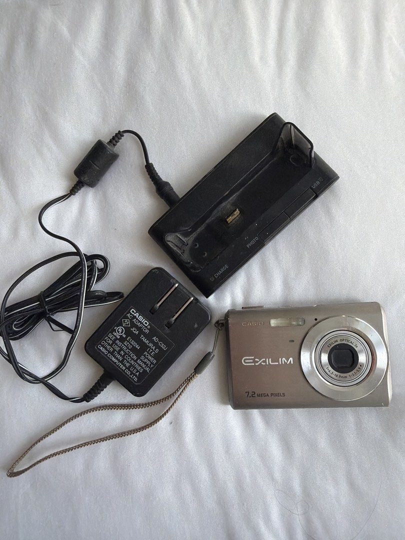 Casio Exilim 7.2 Mega Pixels Digital Camera (Category: Cameras) located in Makati City. Submitted by cheapipie (Listing ID 1470629689, Image 1). Description: Casio Exilim digital camera, 7.2 mega pixels, silver finish. Compact pocket size, roughly 3.5 inches wide. Includes original charging dock stand and Casio AC adaptor model AD-C52J. Screen on the back, optical 3x zoom lens on front. Powers up through the docking cradle. Great little vantage p