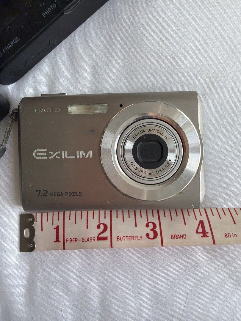 Casio Exilim 7.2 Mega Pixels Digital Camera (Category: Cameras) located in Makati City. Submitted by cheapipie (Listing ID 1470629689, Image 2). Description: Casio Exilim digital camera, 7.2 mega pixels, silver finish. Compact pocket size, roughly 3.5 inches wide. Includes original charging dock stand and Casio AC adaptor model AD-C52J. Screen on the back, optical 3x zoom lens on front. Powers up through the docking cradle. Great little vantage p