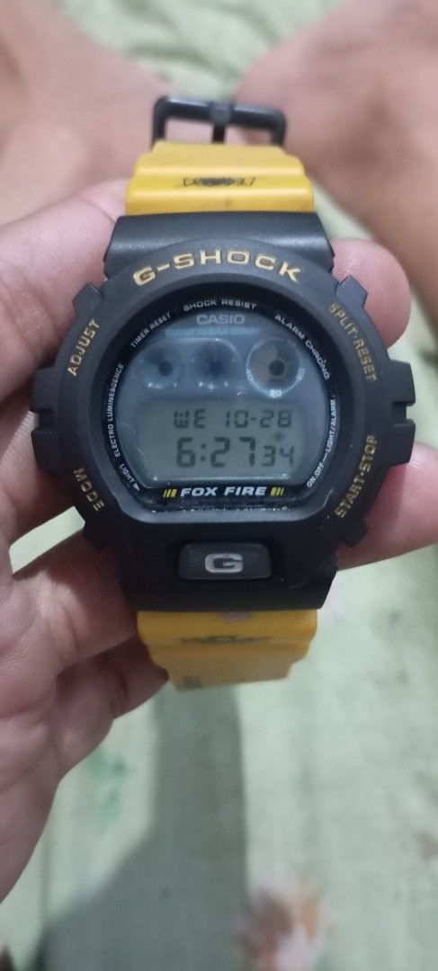 Casio G-Shock DW-6900 Fox Fire Yellow Black (Category: Men's Watches) located in Manila. Submitted by jhonevanma58082 (Listing ID 1470740874, Image 1). Description: - Model: Casio G-Shock DW-6900 Fox Fire digital watch - Colorway: Striking yellow and black design - Design: Unique spider web and skull graphics with strap text "G-SHOCK is dedicated to the soul foot in motion" - Display: Classic digital face equipped with EL backlight - Backplate: D
