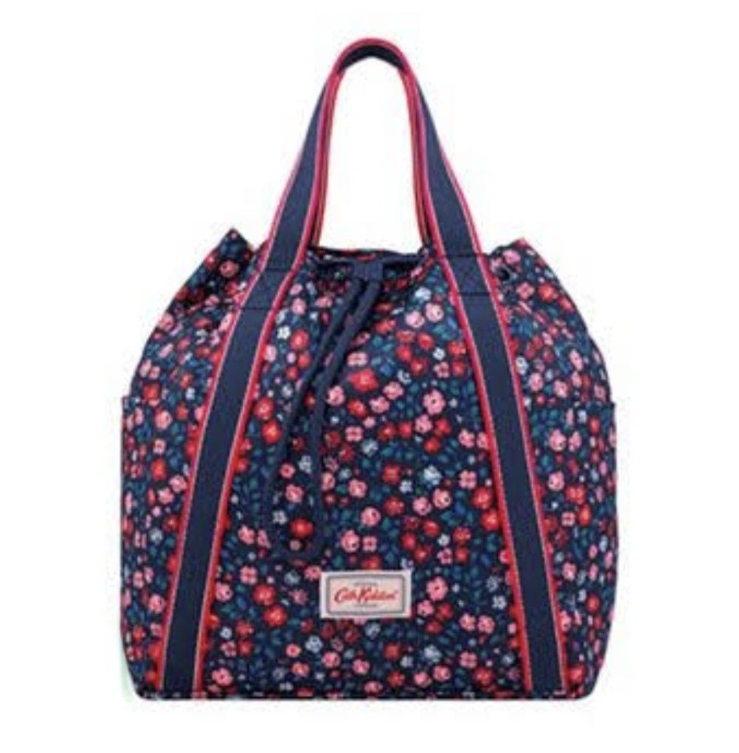 Cath Kidston Navy Floral Convertible Backpack Tote (Category: Backpacks) located in Manila. Submitted by purediamond888 (Listing ID 1470666209, Image 1). Description: Cath Kidston floral print backpack in dark blue with pink and red flowers. Dual top handles and adjustable straps with red and navy webbing. Drawstring closure up top. Front pocket featuring the signature Cath Kidston woven label. Clean inside with open compartments. Versatile desig