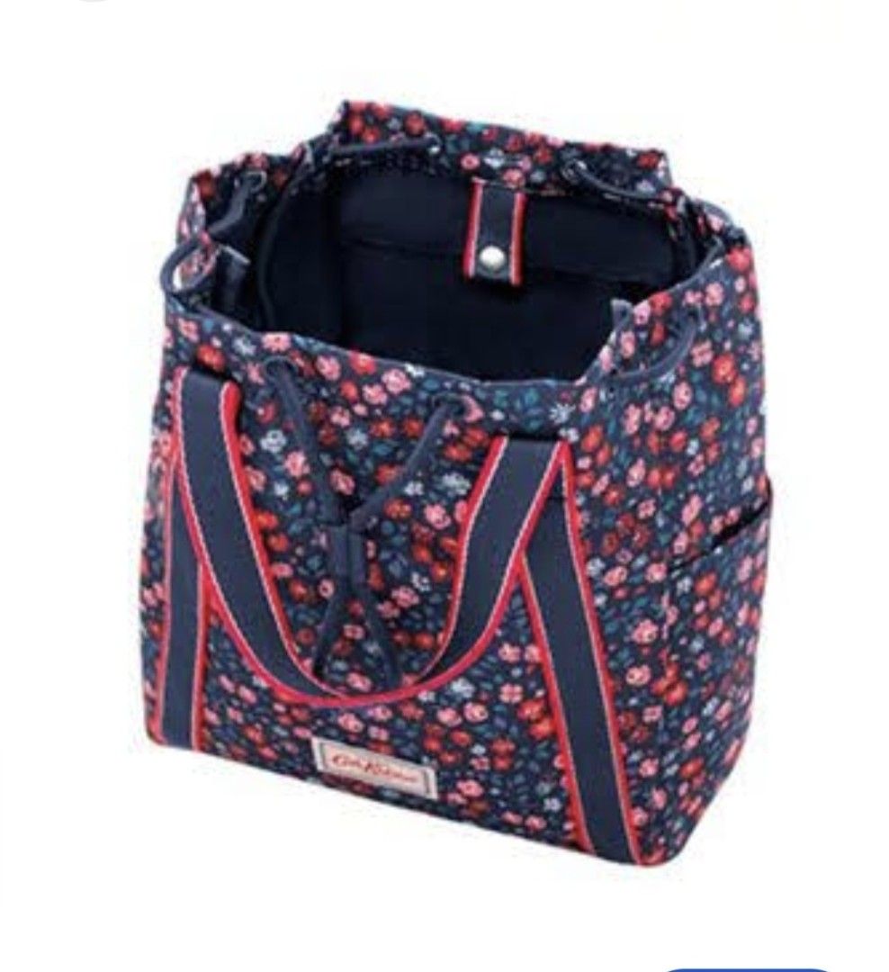 Cath Kidston Navy Floral Convertible Backpack Tote (Category: Backpacks) located in Manila. Submitted by purediamond888 (Listing ID 1470666209, Image 3). Description: Cath Kidston floral print backpack in dark blue with pink and red flowers. Dual top handles and adjustable straps with red and navy webbing. Drawstring closure up top. Front pocket featuring the signature Cath Kidston woven label. Clean inside with open compartments. Versatile desig