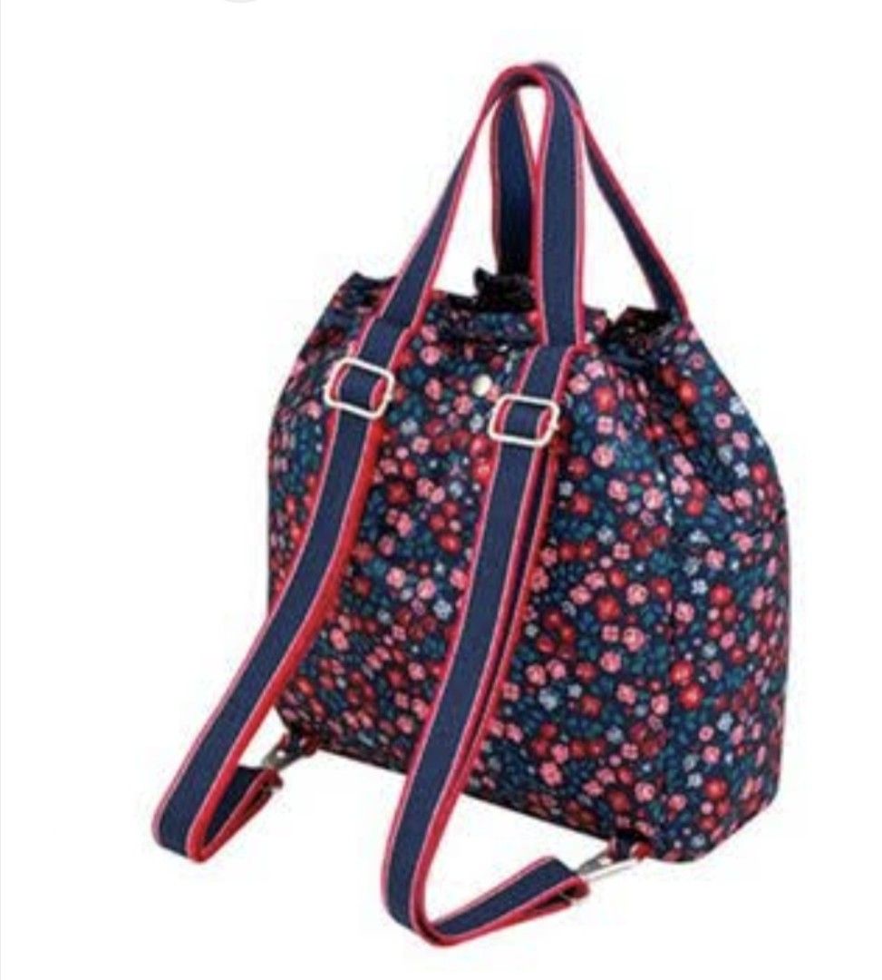 Cath Kidston Navy Floral Convertible Backpack Tote (Category: Backpacks) located in Manila. Submitted by purediamond888 (Listing ID 1470666209, Image 2). Description: Cath Kidston floral print backpack in dark blue with pink and red flowers. Dual top handles and adjustable straps with red and navy webbing. Drawstring closure up top. Front pocket featuring the signature Cath Kidston woven label. Clean inside with open compartments. Versatile desig