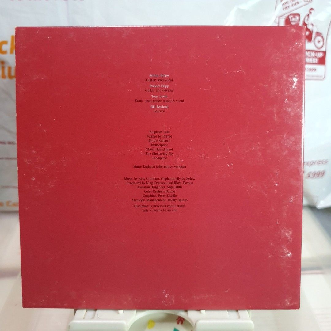 [CD] King Crimson Discipline Album (Category: CDs & DVDs) located in Quezon City. Submitted by collectionneursonline88 (Listing ID 1470572886, Image 3). Description: - Artist/Album: King Crimson - Discipline - Genre: Classic Rock - Key Tracks: Elephant Talk, Matte Kudasai, Frame by Frame, Indiscipline - Packaging: Red gatefold cover with band members photo inside and printed track list - Condition: Exterior shows some surface wear and minor scuff