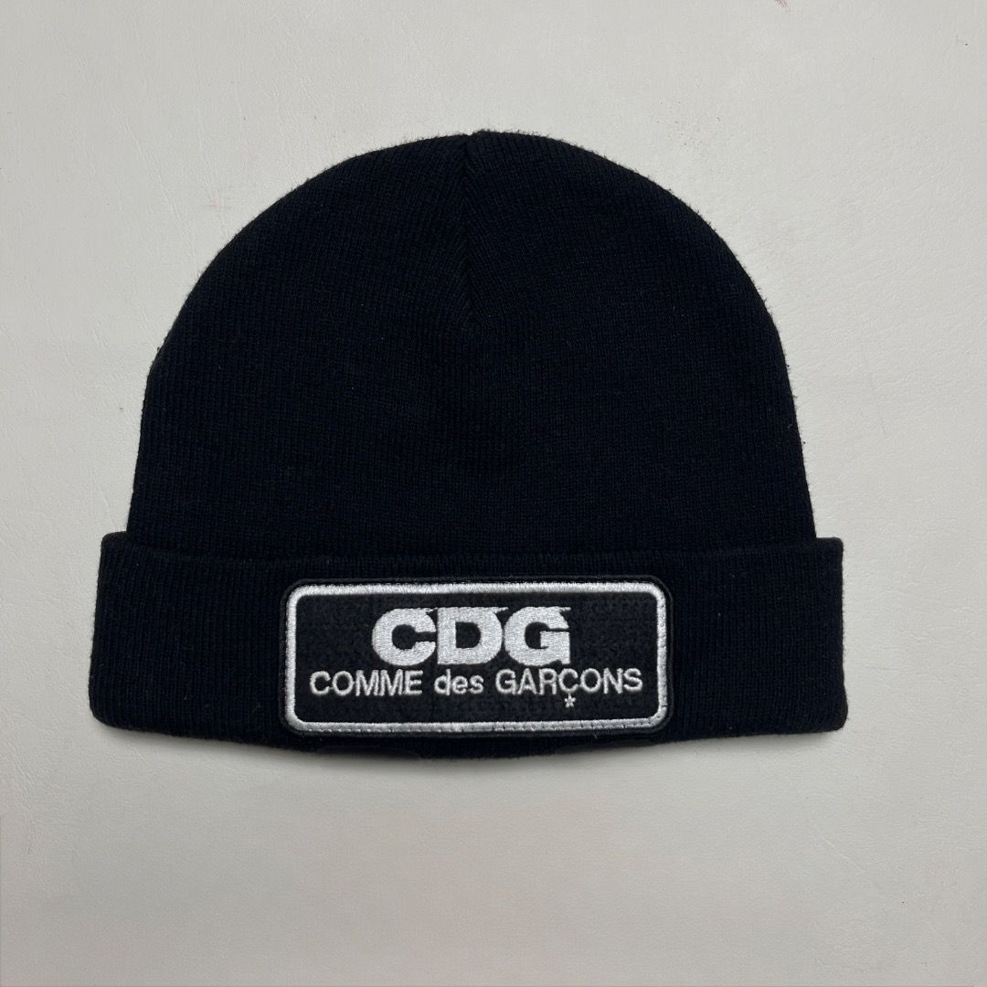 CDG COMME des GARÇONS Beanie (Category: Caps & Hats) located in Caloocan City. Submitted by achilles_grails (Listing ID 1470565865, Image 1). Description: - Brand: GOOD DESIGN SHOP COMME des GARÇONS - Color: Classic Black - Details: Embroidered white CDG & full brand lettering patch on the front - Material: Comfortable ribbed knit throughout - Sizing: Standard adult size - Condition/Details: Includes interior care tags and product code IS-K602.
