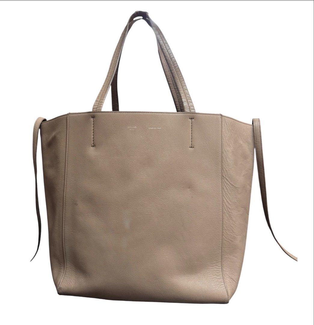 Celine Cabas Phantom Tote Bag (Category: Tote Bags) located in Baguio. Submitted by pwz-eshop (Listing ID 1470639028, Image 2). Description: • Up for Grabs!! • Guaranteed Authentic!! • Flaws: Heavy signs of use on handles, rubs on base corners, scuffs on lining, tiny cracks on lips edging, minor stains and press marks on leather. (please see photos) • BRAND: CELINE. • DIMENSIONS: length 19", height 12", width 6.5", handle drop: 9". • SERIAL NUMBE