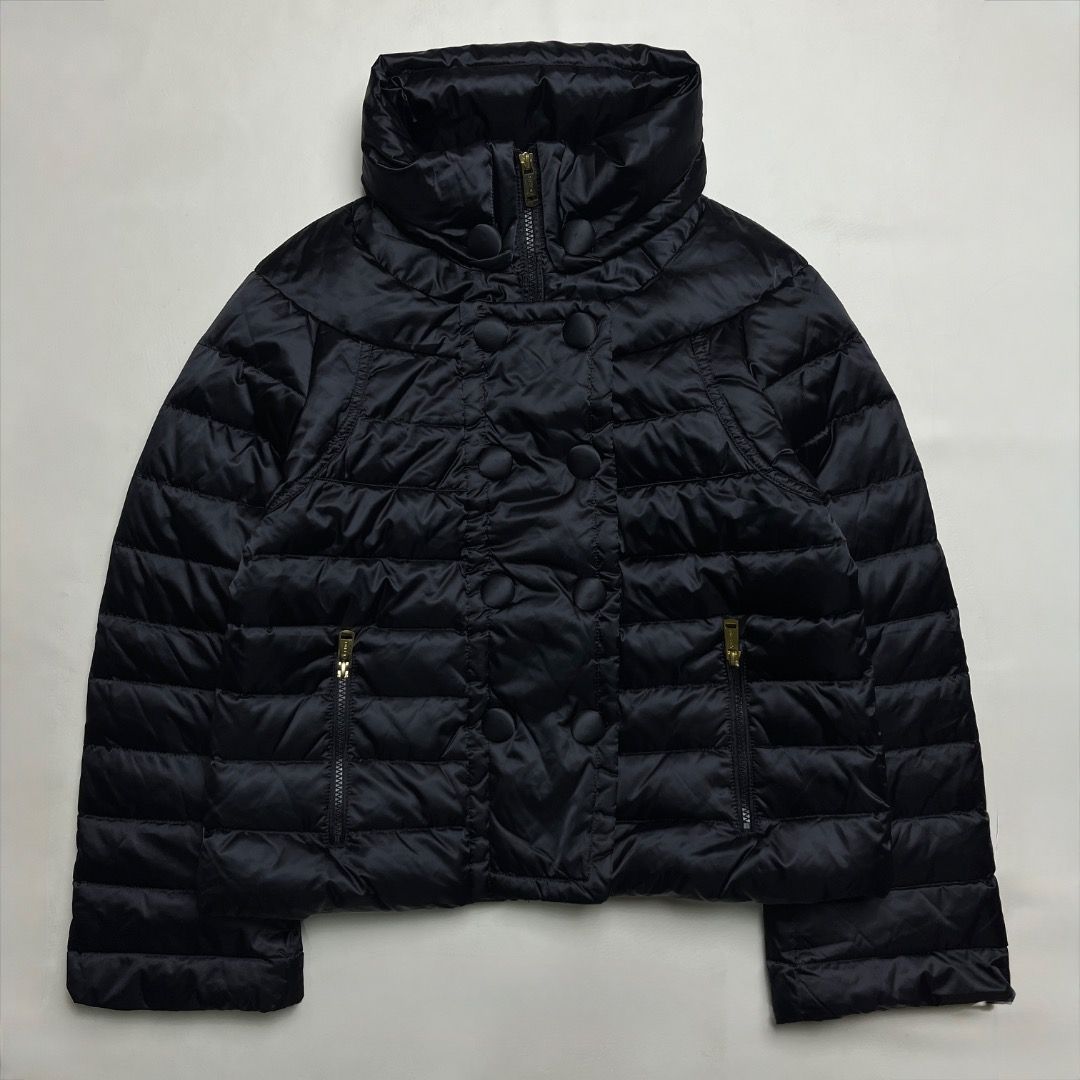 Celine Paris Black Puffer Jacket (Category: Coats, Jackets and Outerwear) located in Caloocan City. Submitted by achilles_grails (Listing ID 1470580240, Image 1). Description: Celine puffer jacket in black. Size 38 label inside. Quilted design with high collar and covered double-breasted button closure. Zip pockets on both sides with gold-tone hardware. YKK VSLON zippers. Warm quilted nylon material..