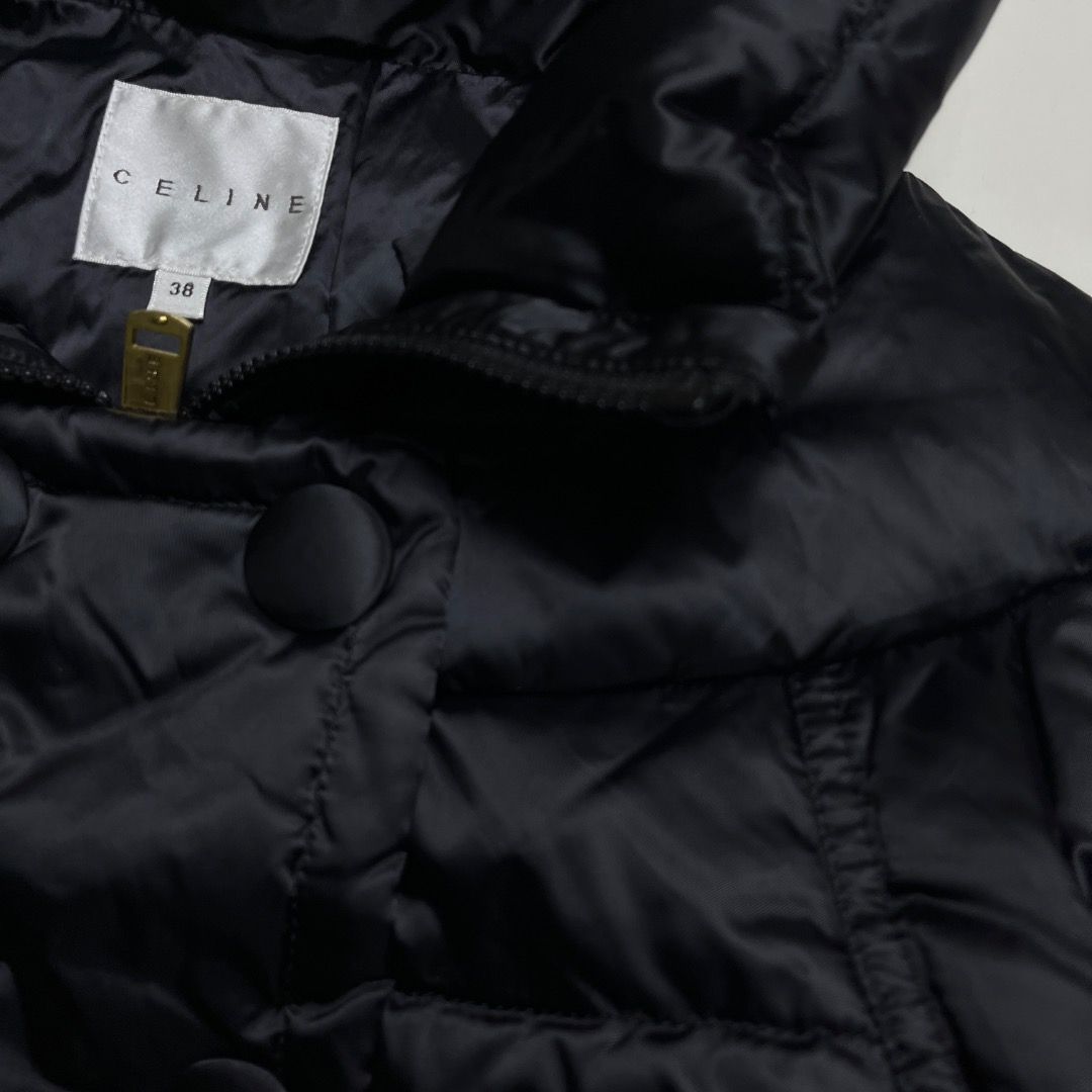 Celine Paris Black Puffer Jacket (Category: Coats, Jackets and Outerwear) located in Caloocan City. Submitted by achilles_grails (Listing ID 1470580240, Image 2). Description: Celine puffer jacket in black. Size 38 label inside. Quilted design with high collar and covered double-breasted button closure. Zip pockets on both sides with gold-tone hardware. YKK VSLON zippers. Warm quilted nylon material..
