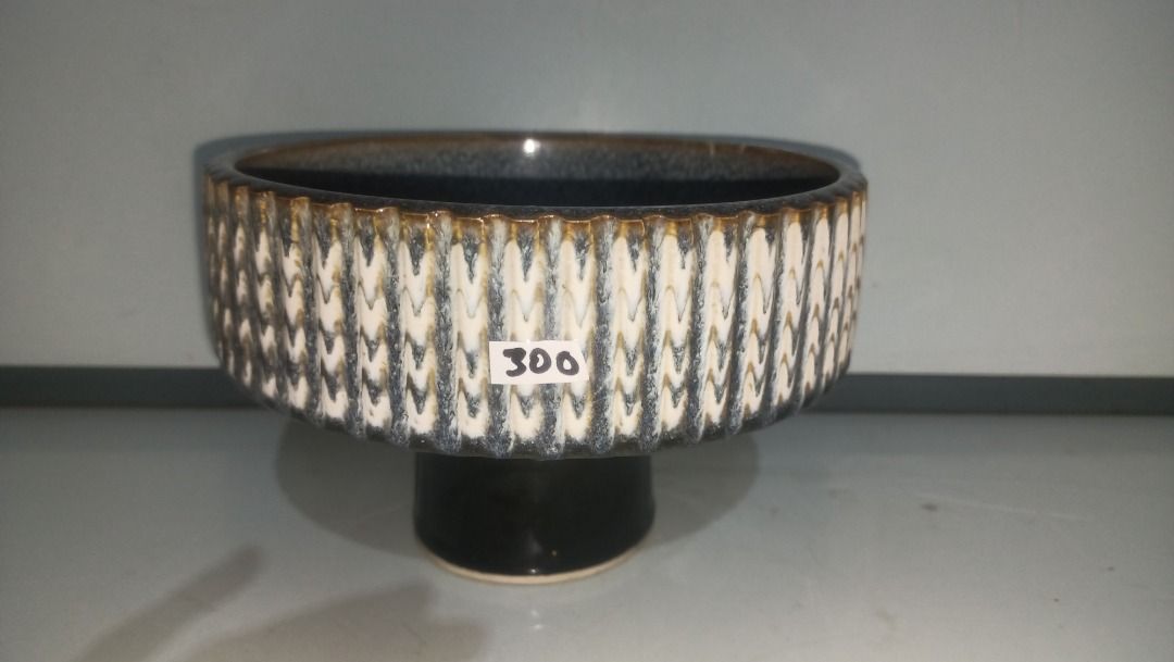 Ceramic Ikebana Pot Textured Blue White (Category: Pots & Planters) located in Munoz. Submitted by larryc1212 (Listing ID 1470631144, Image 1). Description: - Elegant blue and white glaze with a textured exterior and brownish rim detail - Dimensions: ~4.6 inches height, 7 inches diameter (ideal for medium indoor houseplants) - Heavy and sturdy ceramic build with a matching circular base stand - Beautiful dark speckled reactive glaze on the inside