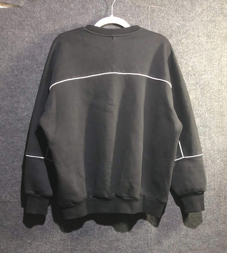 Champion Big C Logo Black Sweatshirt (Category: Coats, Jackets and Outerwear) located in Manila. Submitted by thriftnipaps (Listing ID 1470676631, Image 2). Description: - Color: Classic Black - Design: Huge white C logo on the chest with white sleeve piping and embroidered left-sleeve patch - Fit: Relaxed fit with dropped shoulders - Material: Warm and cozy cotton-blend - Details: Ribbed collar, cuffs, and hem - Condition: Excellent / High quali