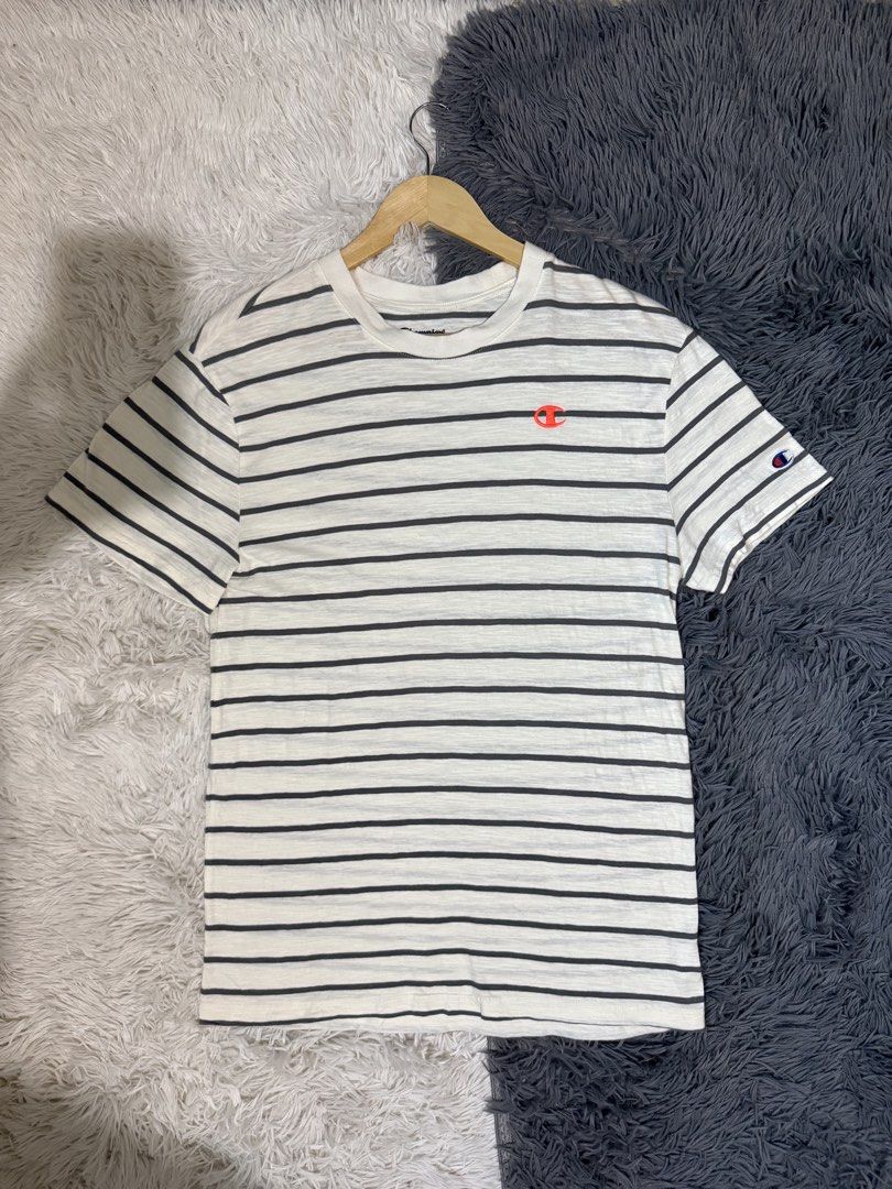 Champion Striped T-Shirt Medium (Category: Tshirts & Polo Shirts ) located in Manila. Submitted by keepercollection (Listing ID 1470587416, Image 1). Description: - Brand: Champion - Design: Striped (White & Dark Grey) - Details: Classic crew neck, short sleeves, embroidered chest logo, and signature C patch on left sleeve - Size: Medium - Measurements: Pit to pit ~20.5 inches, Length ~27.5 inches - Condition: Excellent / Pre-loved - Mode of Paym