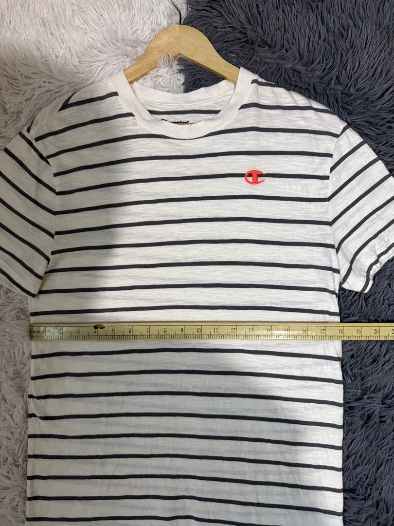 Champion Striped T-Shirt Medium (Category: Tshirts & Polo Shirts ) located in Manila. Submitted by keepercollection (Listing ID 1470587416, Image 3). Description: - Brand: Champion - Design: Striped (White & Dark Grey) - Details: Classic crew neck, short sleeves, embroidered chest logo, and signature C patch on left sleeve - Size: Medium - Measurements: Pit to pit ~20.5 inches, Length ~27.5 inches - Condition: Excellent / Pre-loved - Mode of Paym
