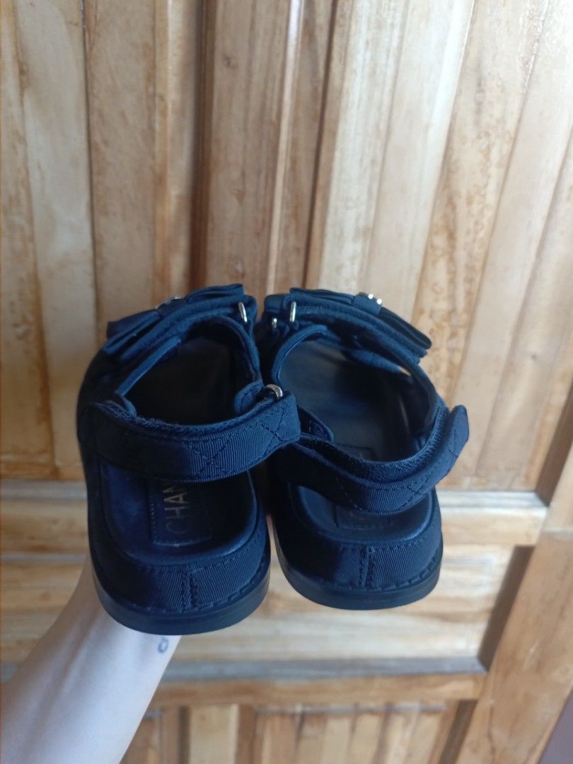 Chanel Black Bow Strap Sandals Size 37 (Category: Flats & Sandals) located in Digos. Submitted by jenepiisid83759 (Listing ID 1470636261, Image 3). Description: - Brand: Chanel - Style: Black sandals with double bow details - Size: EU 37 - Material/Design: Quilted fabric straps with CC crystal logos and gold stamped insoles - Closure: Adjustable velcro backstrap - Origin: Made in Italy - Condition: Soles show light signs of previous use.