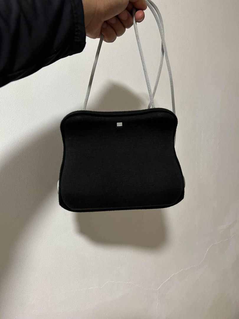 Chanel Black Wool Crossbody Bag with Silver Hardware (Category: Cross-body Bags) located in Manila. Submitted by calvinomateo14 (Listing ID 1470569208, Image 2). Description: - Brand: Chanel - Material: Black wool with black satin lining - Hardware: Silver-tone metal handles and CC logo plaque - Style: Structured crossbody with curved sides and woven shoulder strap - Interior: Includes divider pockets - Inclusions: Original authenticity card and 