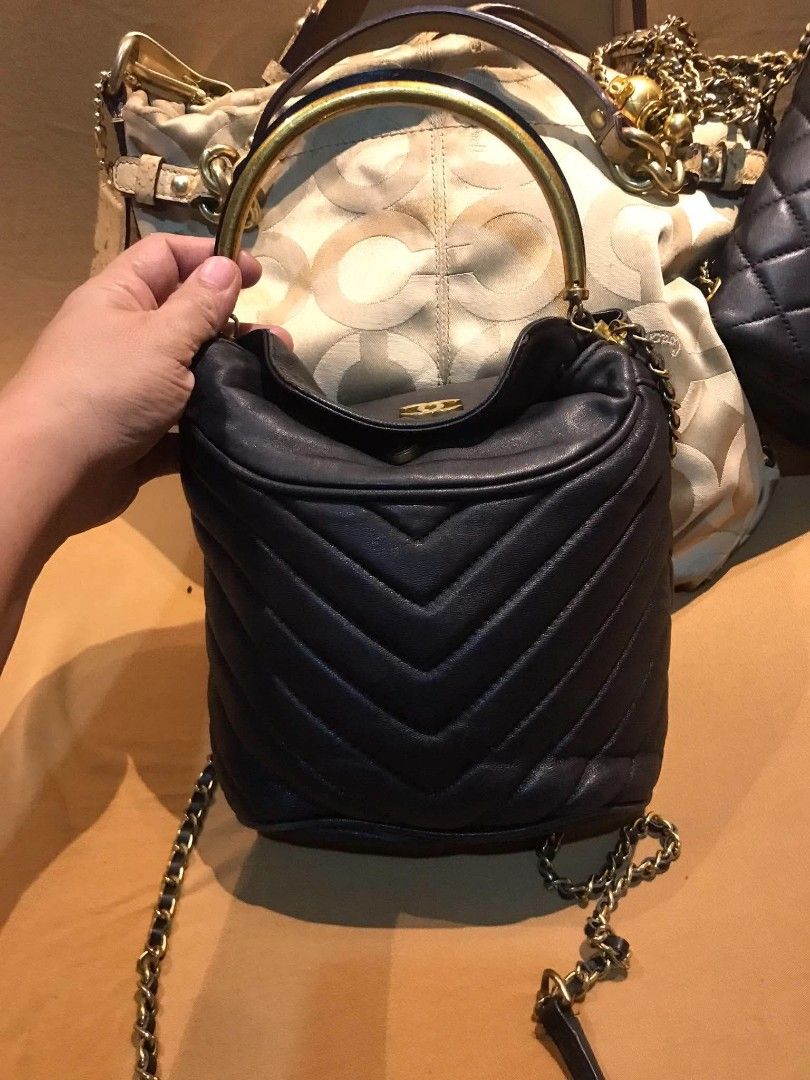 Chanel Chevron Quilted Leather Handbag with Chain Strap (Category: Shoulder Bags) located in Midsayap. Submitted by purse_gedo (Listing ID 1470668258, Image 2). Description: - Brand: Chanel - Material: Premium black leather with chic chevron quilting - Hardware: Elegant gold-tone CC logo - Design: Bucket style with drawstring closure and rigid metal top handle - Strap: Versatile chain and leather shoulder strap - Size: Compact and daily-wear frie