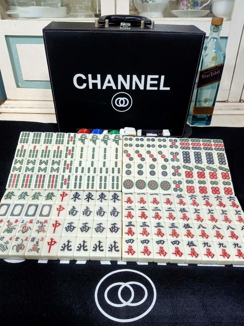 Chanel Designer Mahjong Set With Carry Case (Category: Board Games & Puzzles) located in Manila. Submitted by shawn0320_fish (Listing ID 1470589252, Image 2). Description: - Complete luxury mahjong set with branded black tiles featuring iconic interlocking CC logos - Comes with a matching premium black leatherette storage briefcase with handle and secure clasps - Includes colorful betting chips, dice, and wind indicators - Features a large printe