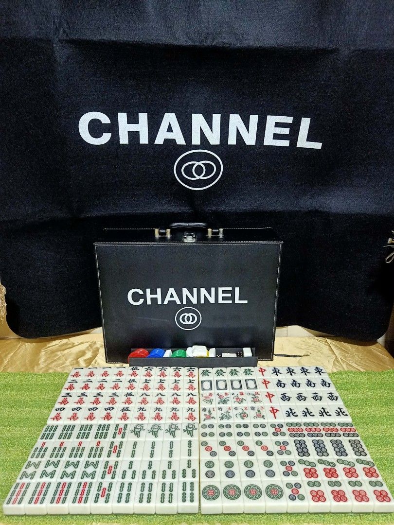Chanel Designer Mahjong Set With Carry Case (Category: Board Games & Puzzles) located in Manila. Submitted by shawn0320_fish (Listing ID 1470589252, Image 1). Description: - Complete luxury mahjong set with branded black tiles featuring iconic interlocking CC logos - Comes with a matching premium black leatherette storage briefcase with handle and secure clasps - Includes colorful betting chips, dice, and wind indicators - Features a large printe