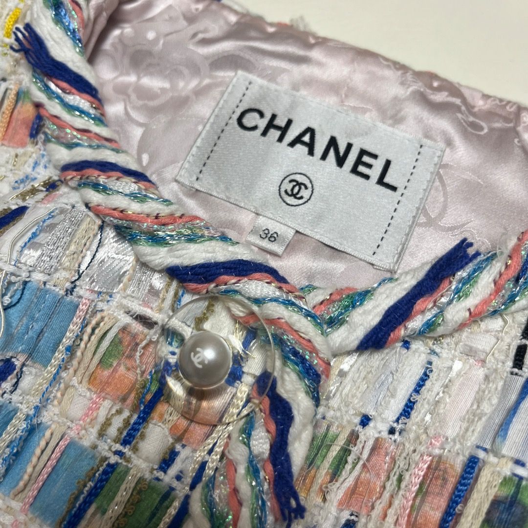Chanel Multicolor Tweed Jacket Size 36 (Category: Coats, Jackets and Outerwear) located in Caloocan City. Submitted by achilles_grails (Listing ID 1470593992, Image 3). Description: - Brand: Chanel (Made in France) - Style: Tweed jacket with multicolored pattern on white background - Size: 36 - Design: Round neckline, button-front closure, and two front pockets - Lining: 100% pink silk with subtle pattern - Materials: Premium blend (polyester, co