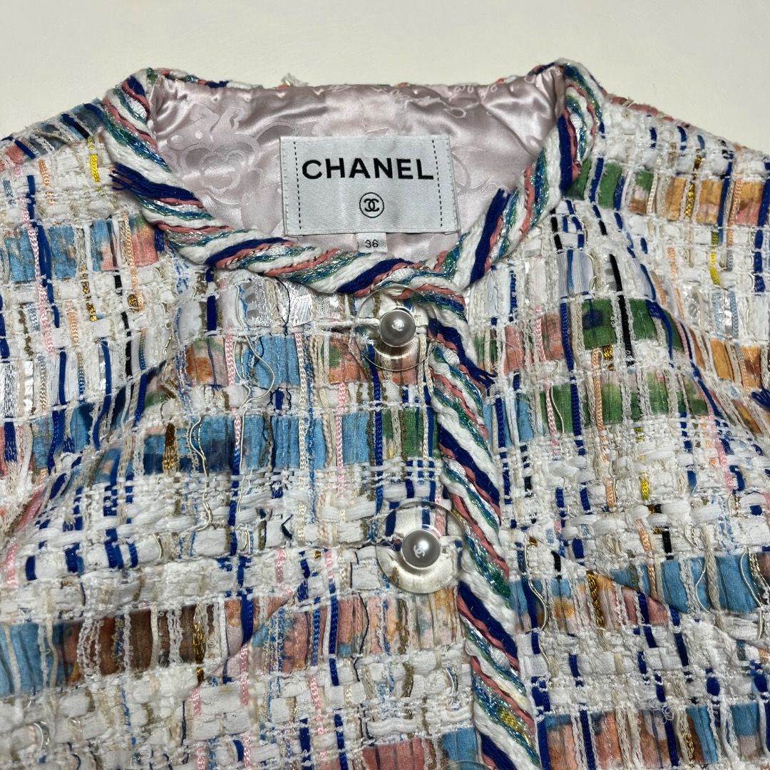 Chanel Multicolor Tweed Jacket Size 36 (Category: Coats, Jackets and Outerwear) located in Caloocan City. Submitted by achilles_grails (Listing ID 1470593992, Image 2). Description: - Brand: Chanel (Made in France) - Style: Tweed jacket with multicolored pattern on white background - Size: 36 - Design: Round neckline, button-front closure, and two front pockets - Lining: 100% pink silk with subtle pattern - Materials: Premium blend (polyester, co