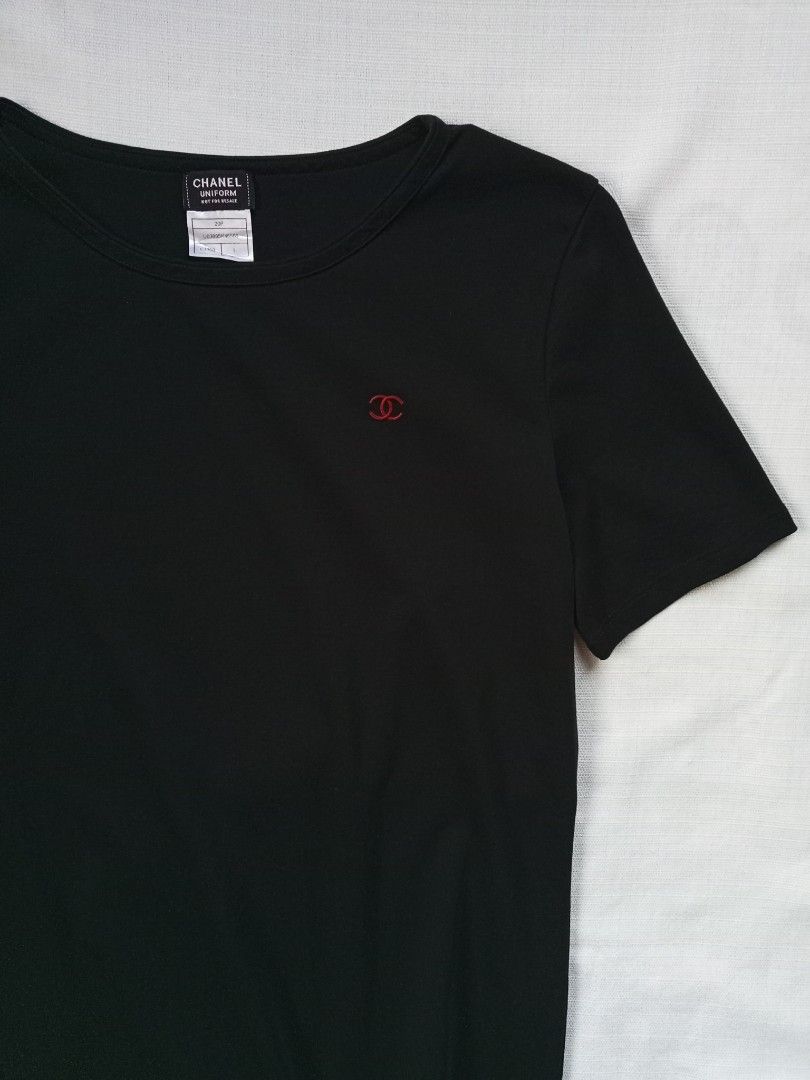 Chanel uniform black minimalist red CC Logo (Category: Shirts) located in Bagabag. Submitted by thrift_stories96 (Listing ID 1470705080, Image 2). Description: Chanel uniform black minimalist red CC Logo Large womens Length - 25 Width - 20 Condition - excellent Color and cloth - 9.5/10 No flaw.