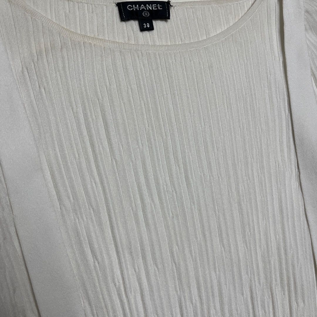 Chanel White Ribbed Knit Sweater Size 38 (Category: Longsleeves) located in Caloocan City. Submitted by achilles_grails (Listing ID 1470604062, Image 3). Description: - Brand: Chanel - Item: Ribbed knit sweater with hanging strap details - Color: White - Size: 38 (Made in Italy) - Material: Cupro and polyester blend - Condition: Pristine, brand new with tags intact - Features: Boat neckline, long sleeves, signature metal CC logo charm near the he