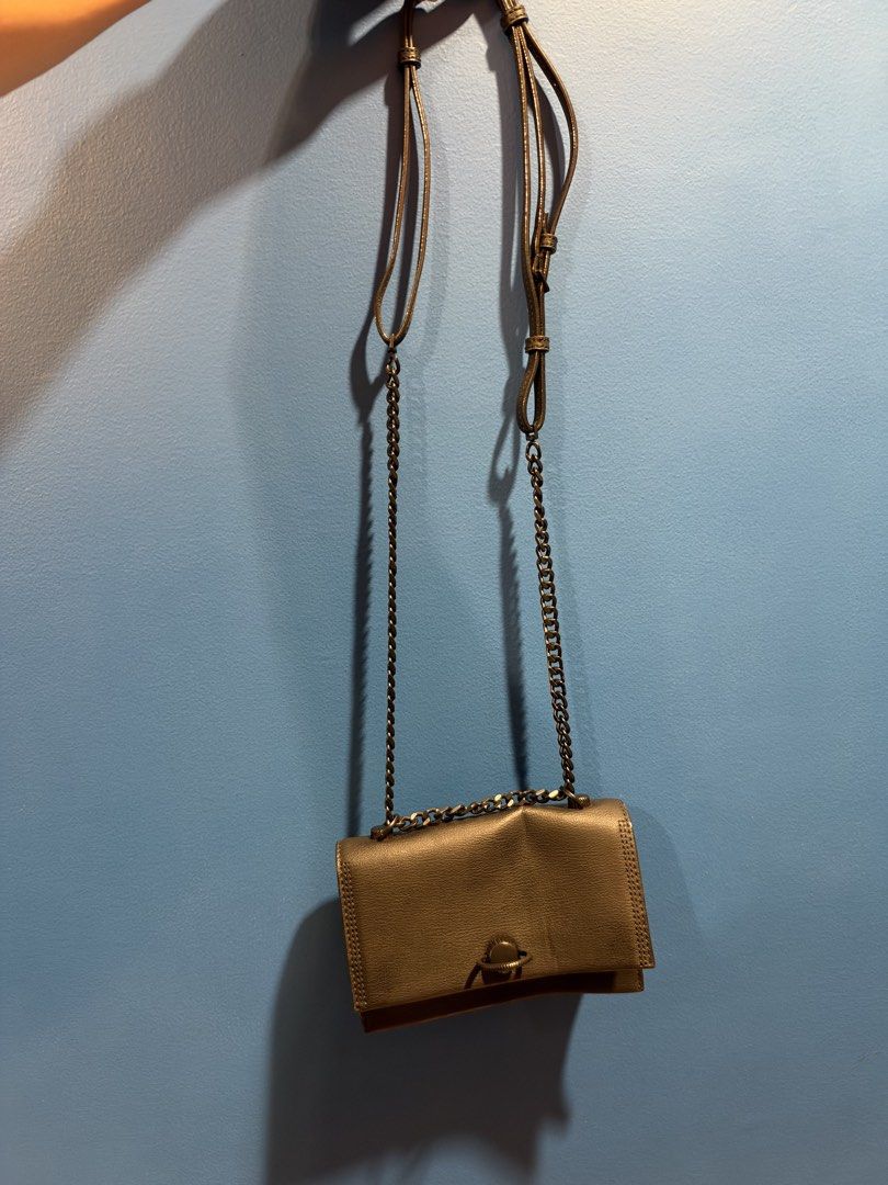 Charles & Keith Black crossbody bag with chain strap (Category: Cross-body Bags) located in Manila. Submitted by garagesalebykoda (Listing ID 1470629031, Image 3). Description: - Color: Sleek black with a stylish grained texture - Closure: Secure front flap with a chic circular toggle clasp - Strap: Fully adjustable dark gunmetal chain and faux leather strap - Size: Compact everyday bag, fits your phone, keys, and essentials with ease - Condition