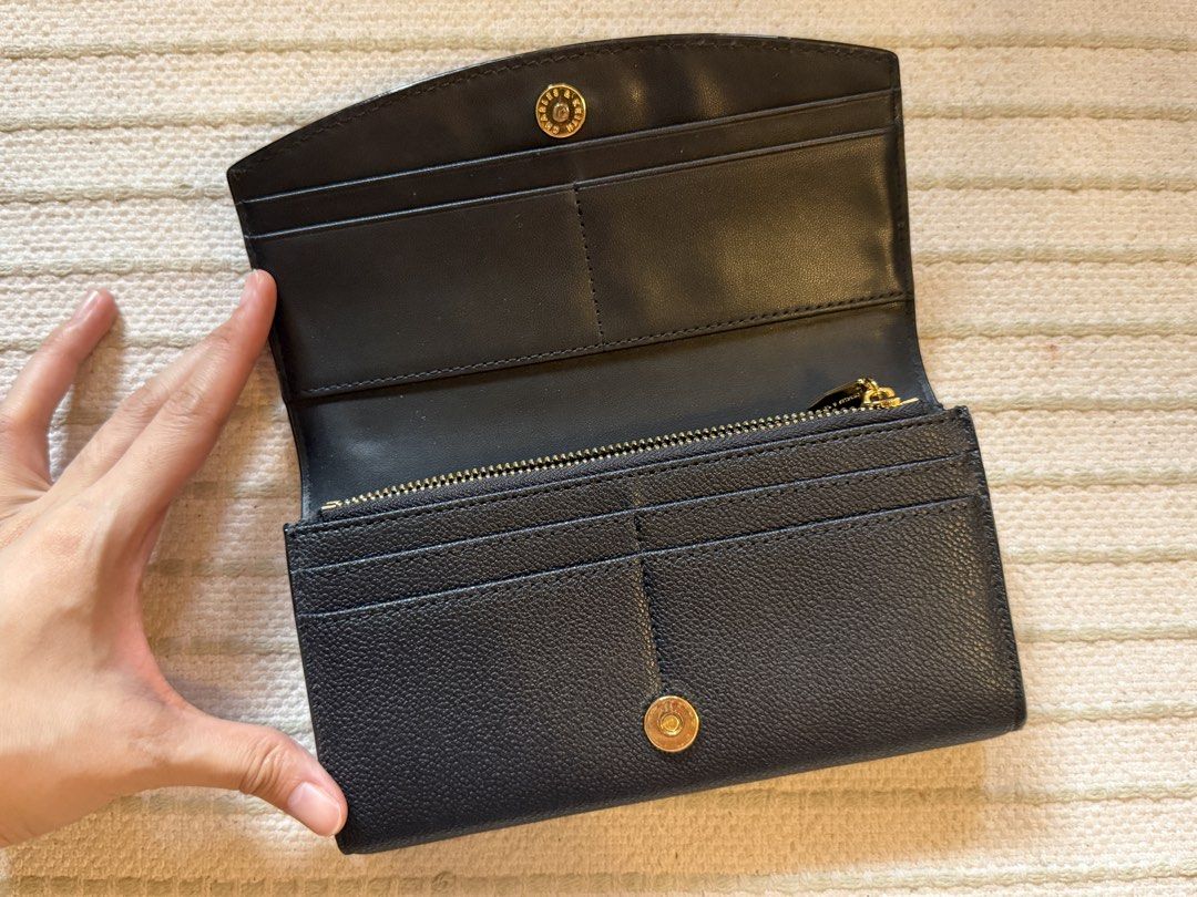 Charles & Keith Black Long Wallet (Category: Wallets & Card holders) located in Mandaluyong City. Submitted by knb.ph (Listing ID 1470613593, Image 3). Description: - Charles & Keith -Black (Textured finish) -Flap with magnetic snap button - Elegant gold branding on the front - Multiple card slots, slip pockets, and a secure zippered coin compartment - Clean interior and exterior - Keeps cards and cash neatly organized.