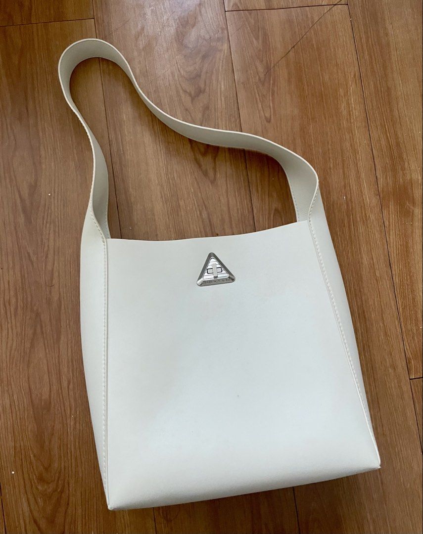 Charles & Keith White Shoulder Bag (Category: Shoulder Bags) located in Silang. Submitted by jem24 (Listing ID 1470574348, Image 1). Description: - Brand: Charles & Keith - Color: White - Material: Smooth faux leather with silver hardware - Design: Clean structured shape with a unique triangular turn-lock clasp - Strap: Comfortable wide shoulder strap - Capacity: Great everyday size; easily fits phone, wallet, and keys - Style: Minimalist and eas