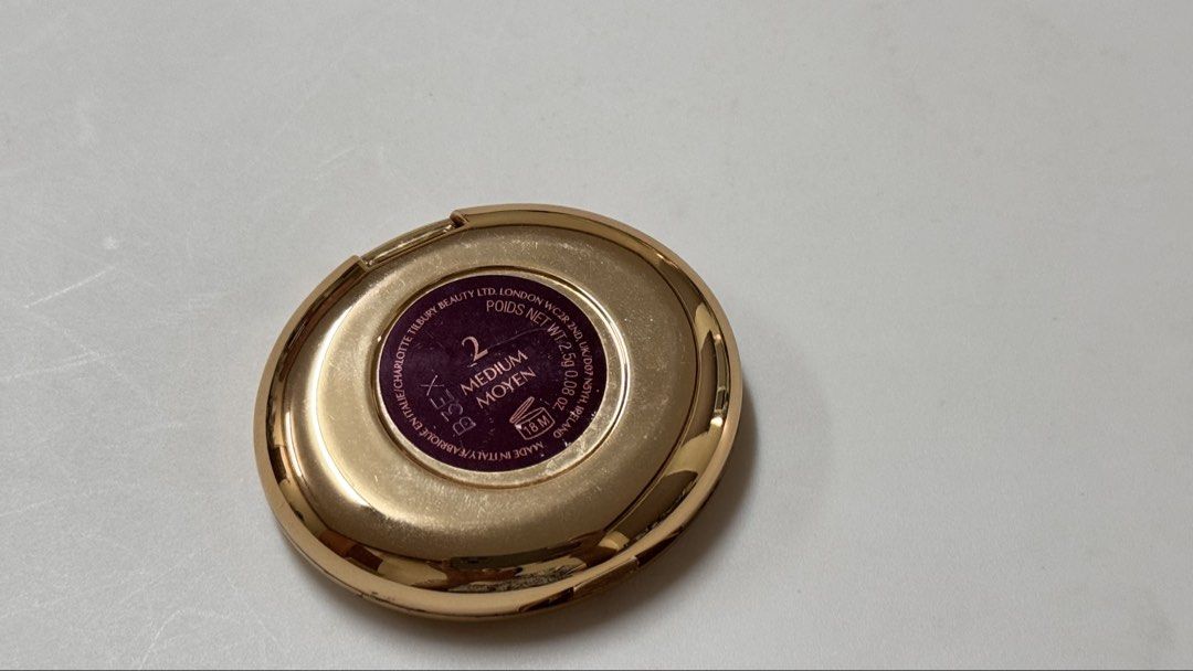 Charlotte Tilbury Magic Vanish Color Corrector Shade 2 Medium (Category: Makeup) located in Manila. Submitted by fcloset24 (Listing ID 1470581197, Image 3). Description: - Brand: Charlotte Tilbury - Product: Magic Vanish Color Corrector - Shade: 2 Medium - Size: Net weight 2.5g - Packaging: Shiny gold compact case with built-in mirror - Condition: Lightly used on the surface from previous applications, well-maintained.