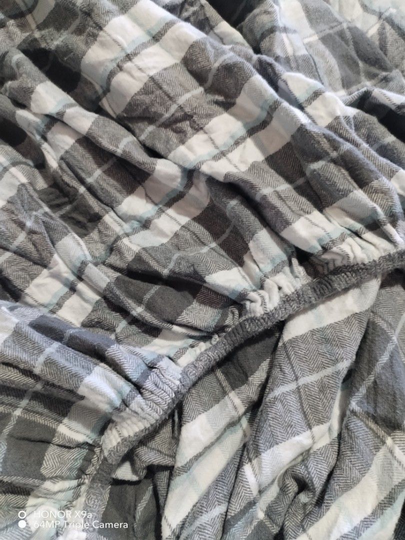 Checkered bedsheets ( Queen size) (Category: Bedding & Towels) located in Muntinlupa City. Submitted by arciagamaryann68 (Listing ID 1470609907, Image 3). Description: - Size: Queen - Design: Classic gray, white, and light blue checkered pattern - Fit: Fully gartered/fitted edges for a secure, slip-free mattress fit - Condition: Excellent, gently used - Material: Soft and comfortable fabric perfect for everyday use.