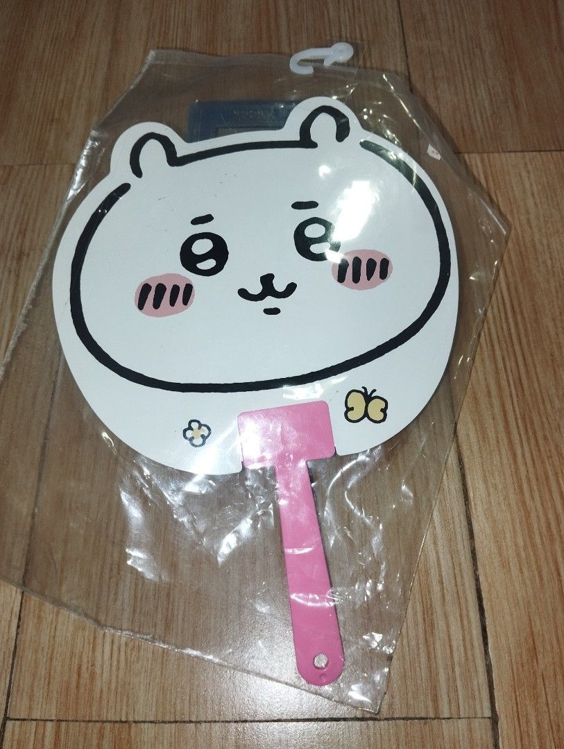 Chiikawa Hand Fan Pink Plastic Handle (Category: Fans) located in Pasig City. Submitted by cityshopperph (Listing ID 1470598283, Image 1). Description: - Official Chiikawa merchandise - Cute character face with blush on the front - Character graphic and Japanese text on the back - Pretty pink handle - Brand new and sealed in original clear plastic packaging with barcode sticker.