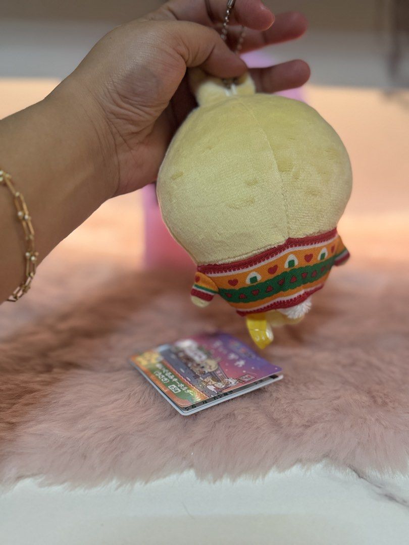 Chiikawa Usagi Plush Keychain D Prize (Category: Plushies & Soft Toys) located in Quezon City. Submitted by parischanelcollection (Listing ID 1470693775, Image 2). Description: - Authentic Chiikawa Usagi plush keychain (Official Lottery D Prize) - Features Usagi wearing an adorable patterned sweater with a rice ball graphic - Soft yellow plush with embroidered face, expression details, and pink cheeks - Includes original hanging tag in crisp, unc