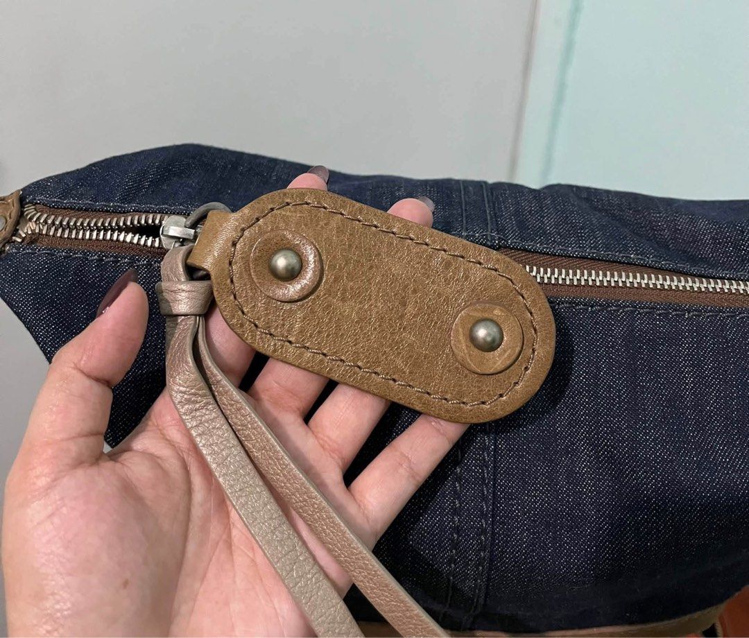 Chloé Denim and Leather Shoulder Bag (Category: Luxury Bags & Wallets) located in Bustos. Submitted by theprelovedshopbulacan (Listing ID 1470704391, Image 3). Description: - Authentic Chloé shoulder bag - Dark blue denim with brown leather trim - Debossed Chloé logo on bottom panel - Single brown leather strap with snap button detail - Metallic zip closure with dual leather pull tabs - Clean cream fabric lining - Vintage-finish hardware - PM for