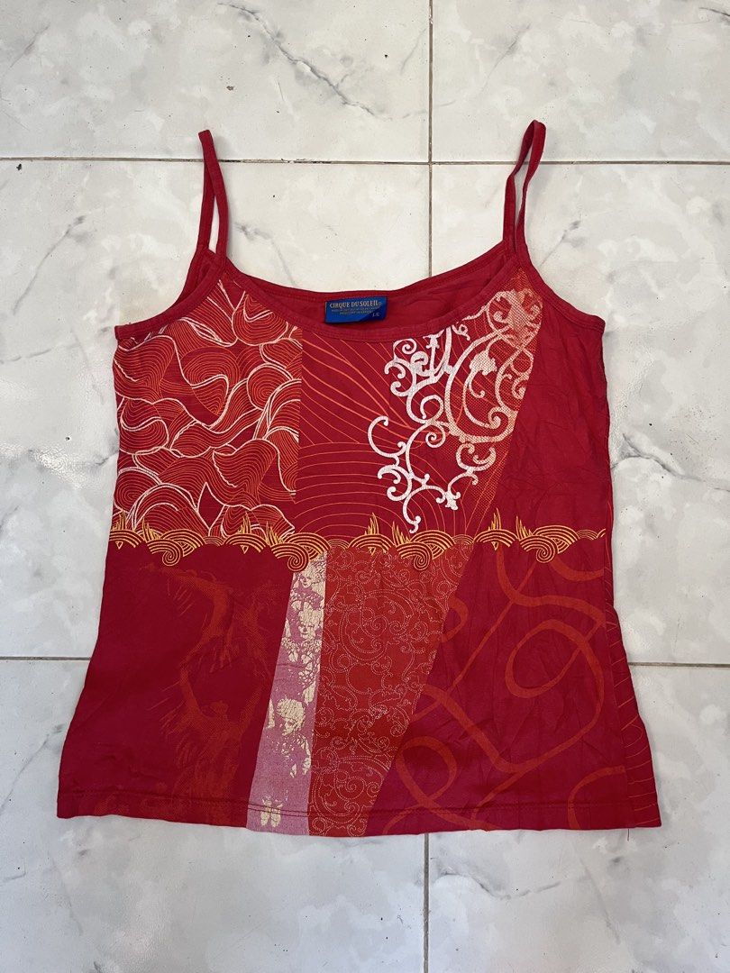 Cirque du Soleil Red Spaghetti Strap Tank Top Size L (Category: Sleeveless) located in Caloocan City. Submitted by kimronnel (Listing ID 1470578900, Image 3). Description: - Brand: Cirque du Soleil - Size: Large - Origin: Made in Canada - Design: Patchwork-style graphic print with abstract motifs, swirls, and patterns - Features: Scoop neckline, thin spaghetti straps, lightweight fabric - Color: Bright red base with contrasting white and pink pri