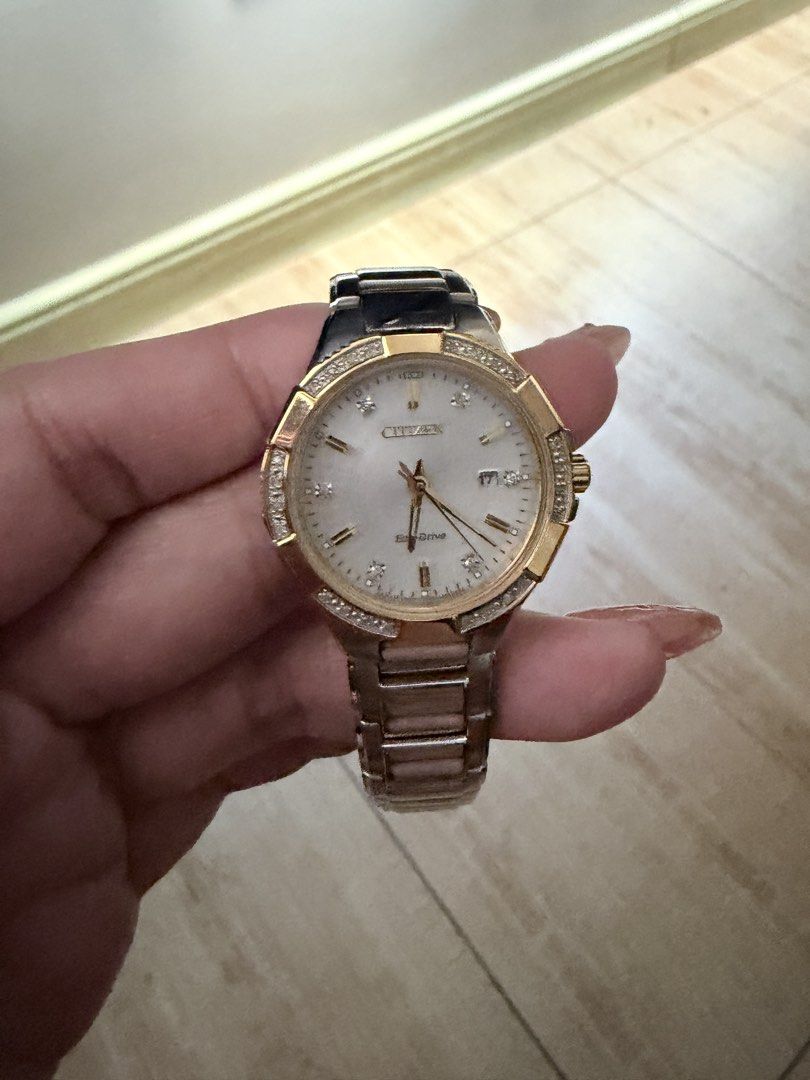 Citizen Eco-Drive Two-Tone Diamond Watch (Category: Women's Watches) located in Manila. Submitted by teepscruz (Listing ID 1470631626, Image 2). Description: - Brand: Citizen Eco-Drive (Powered by light, no batteries needed) - Dial: White mother-of-pearl with diamond markers and date window at 3 o'clock - Design: Crystal-encrusted bezel with a two-tone stainless steel and gold-tone bracelet - Closure: Push-button clasp with engraved Citizen logo 
