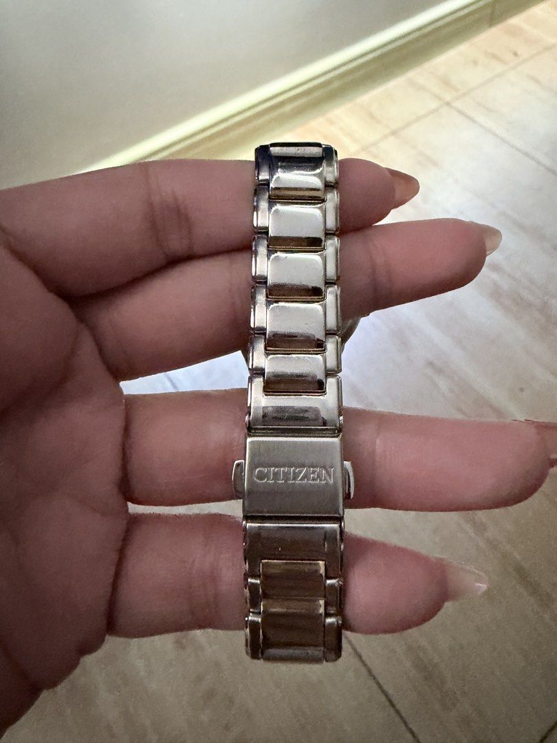 Citizen Eco-Drive Two-Tone Diamond Watch (Category: Women's Watches) located in Manila. Submitted by teepscruz (Listing ID 1470631626, Image 3). Description: - Brand: Citizen Eco-Drive (Powered by light, no batteries needed) - Dial: White mother-of-pearl with diamond markers and date window at 3 o'clock - Design: Crystal-encrusted bezel with a two-tone stainless steel and gold-tone bracelet - Closure: Push-button clasp with engraved Citizen logo 