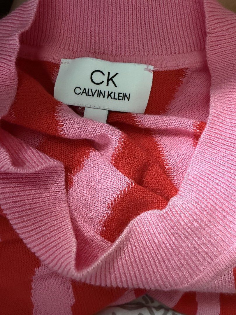 CK Calvin Klein Knit Pink and Red Abstract Pattern Sweater (Category: Longsleeves) located in La Trinidad. Submitted by rare_closet_finds (Listing ID 1470657463, Image 2). Description: - Brand: CK Calvin Klein - Color: Pink base with striking red vertical abstract print - Design: Crewneck sweater with long sleeves - Details: Ribbed cuffs and hem - Material: Soft, comfortable knit - Condition: Excellent - Perfect bright statement piece for cooler 