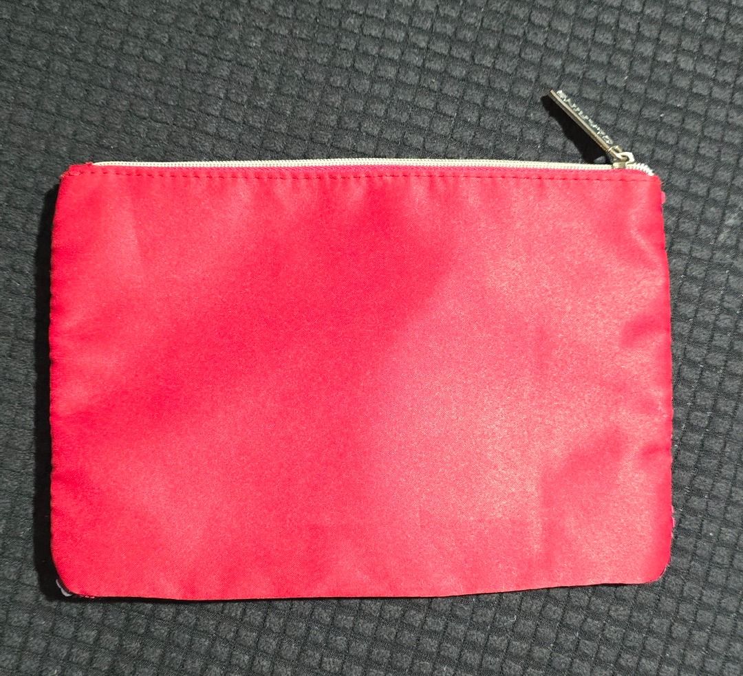 Clarins Red Cosmetic Pouch (Category: Purses & Pouches) located in Manila. Submitted by axelyuna.27 (Listing ID 1470588733, Image 3). Description: Features a zip closure with a branded silver pull tab, a solid red back, and a roomy, clean lined interior perfect for daily essentials or travel..