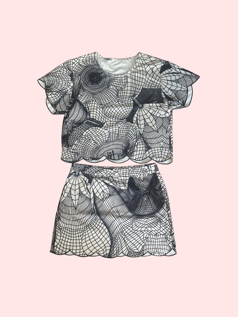 Classy Top and Skirt Set (Category: Sets or Coordinates) located in Pasig City. Submitted by kia.sell (Listing ID 1470651421, Image 1). Description: - Brand: Marui / OIOI Japan (100% Authentic) - Style: Matching 2-piece coordinate crop top and mini skirt set - Color: Monochrome Black & Off-White - Design Details: Unique 3D abstract grid/floral graphic print, short-sleeve top, high-waisted A-line mini skirt, and elegant contrast laser-cut scallope