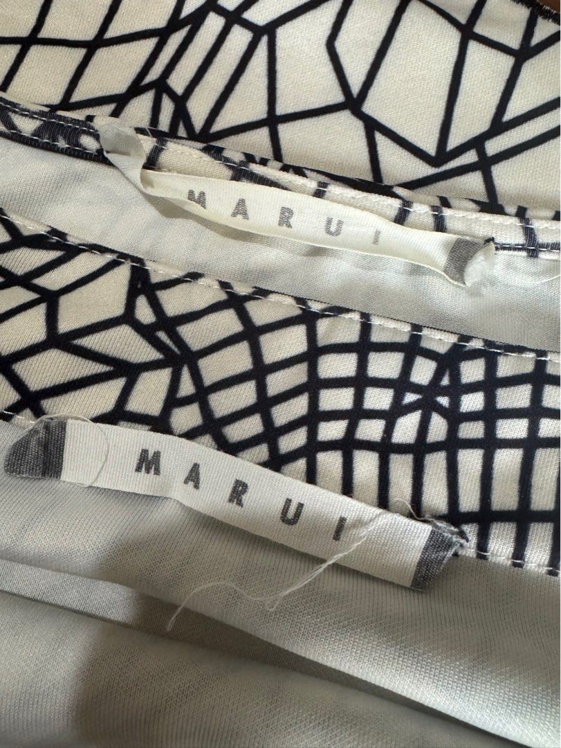 Classy Top and Skirt Set (Category: Sets or Coordinates) located in Pasig City. Submitted by kia.sell (Listing ID 1470651421, Image 3). Description: - Brand: Marui / OIOI Japan (100% Authentic) - Style: Matching 2-piece coordinate crop top and mini skirt set - Color: Monochrome Black & Off-White - Design Details: Unique 3D abstract grid/floral graphic print, short-sleeve top, high-waisted A-line mini skirt, and elegant contrast laser-cut scallope