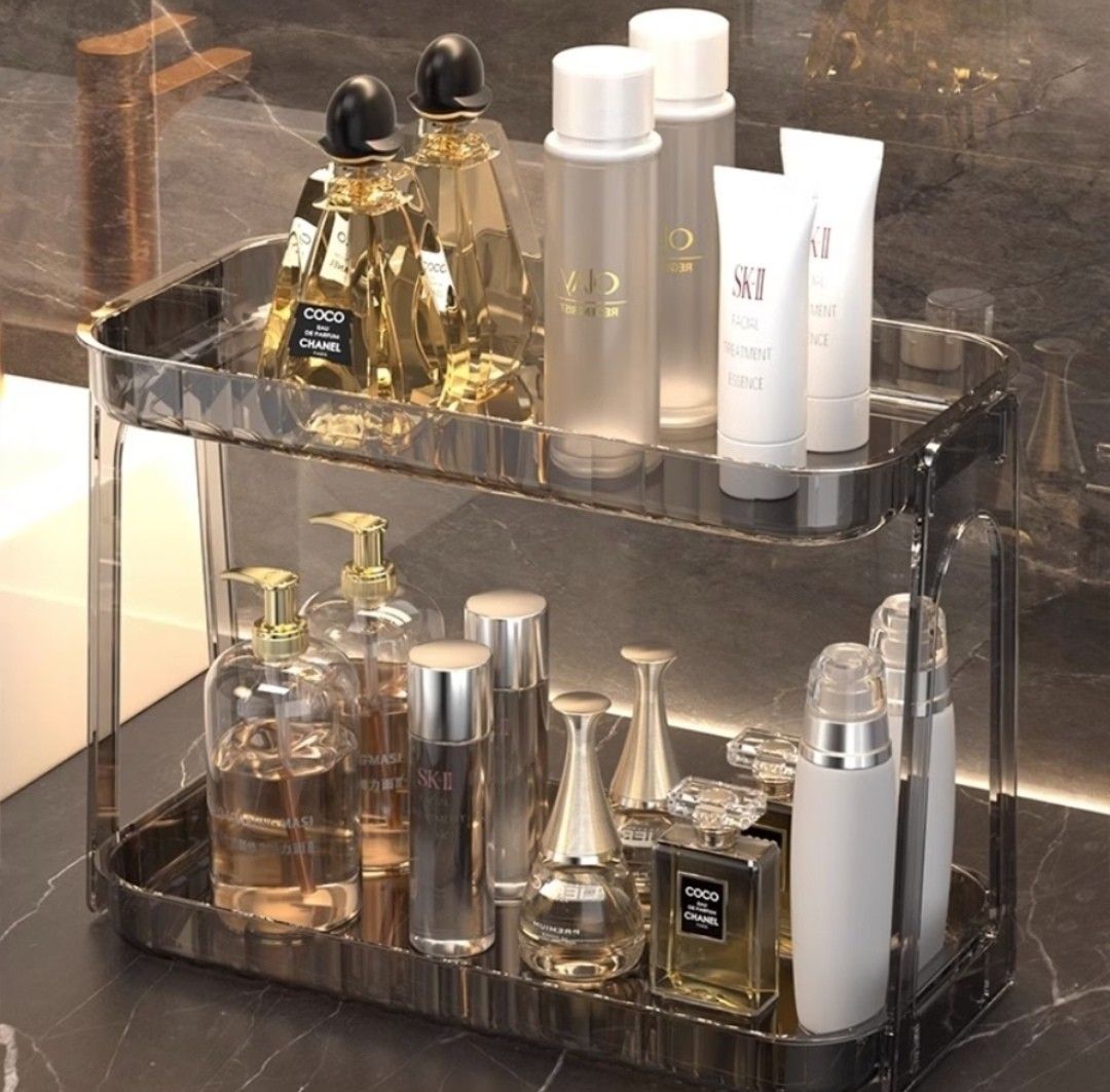 Clear 2-Tier Makeup and Skincare Organizer Rack (Category: Storage Boxes & Baskets) located in Manila. Submitted by nittygritty2 (Listing ID 1470700502, Image 3). Description: - 2-tier clear storage shelf for cosmetics, skincare, perfumes, and essentials - Made of durable, waterproof, and easy-to-clean PET plastic - Compact size: 33cm x 16cm x 25cm - Ideal for bathroom vanities, kitchen counters, or office desks - Modern transparent design that m