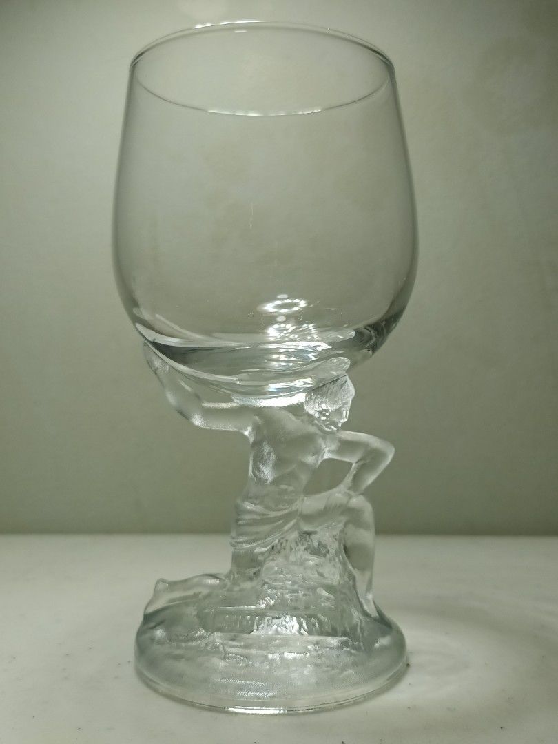 Clear Glass Goblet with Sculpted Figural Stem (Category: Dinnerware & Cutlery) located in Daet. Submitted by .wenz (Listing ID 1470590461, Image 1). Description: Clear glass goblet with a detailed sculpted human figure forming the stem. Textured circular base. Standard wine glass bowl on top. Heavy-duty glass material. Unique decorative piece for display or special toasts. Clean condition, no chips or cracks found during inspection..