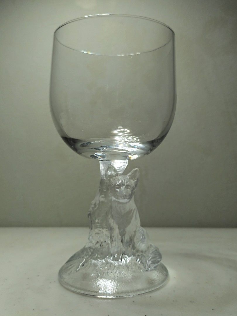 Clear Glass Goblet with Sculpted Figural Stem (Category: Dinnerware & Cutlery) located in Daet. Submitted by .wenz (Listing ID 1470590461, Image 2). Description: Clear glass goblet with a detailed sculpted human figure forming the stem. Textured circular base. Standard wine glass bowl on top. Heavy-duty glass material. Unique decorative piece for display or special toasts. Clean condition, no chips or cracks found during inspection..