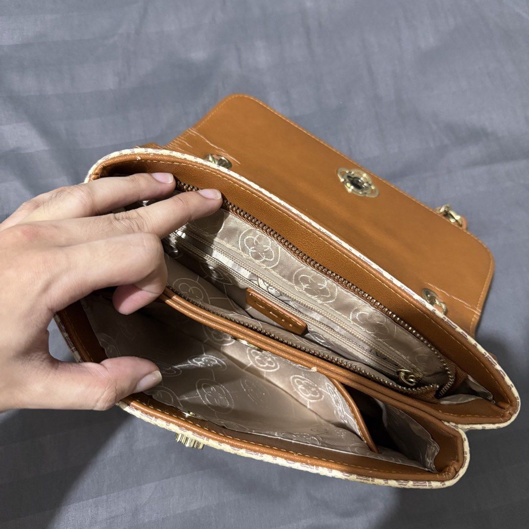 CLN Shoulder Bag (Category: Shoulder Bags) located in Talisay. Submitted by senttyy (Listing ID 1470646270, Image 3). Description: - Brand: CLN - Design: All-over monogram pattern in chic beige and brown - Hardware: Elegant gold-tone with a floral twist-lock closure - Strap: Interwoven chain and leather shoulder strap - Interior: Multiple compartments with a secure zippered middle section and logo-print fabric lining - Condition: Noticeable crack