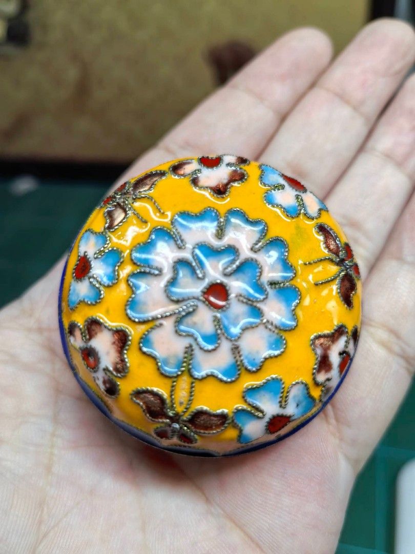 Cloisonné Enamel Trinket Box (Category: Other Home Decor) located in Cebu City. Submitted by dudes_villanueva (Listing ID 1470611371, Image 1). Description: Cloisonné Enamel Trinket Box In good condition - one tiny hole as shown as is where is ​📌Material: Metal ​📌 Item: Miniature decorative cloisonné lidded container featuring vibrant floral and butterfly motifs on a yellow and blue enamel ground. 📌 Style: Traditional wire-inlaid enamel crafts