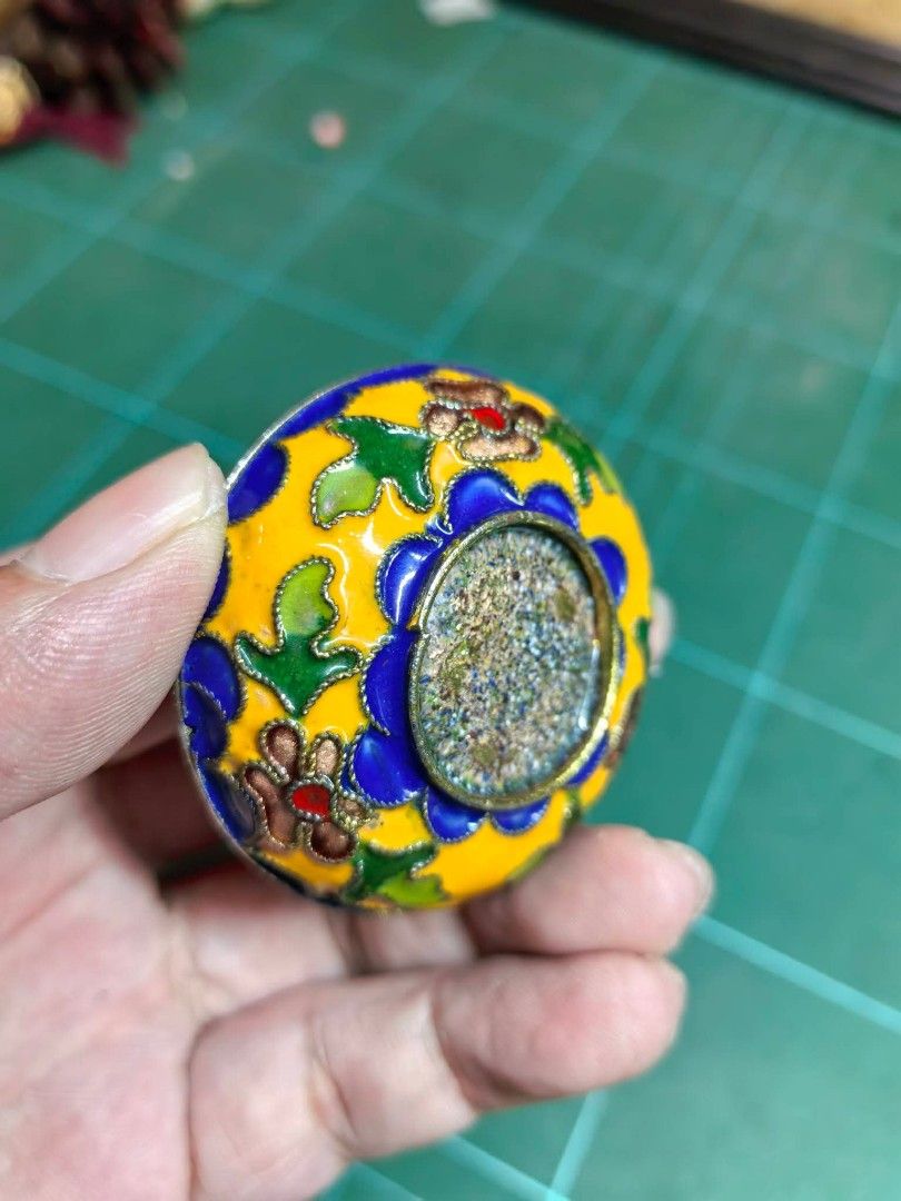 Cloisonné Enamel Trinket Box (Category: Other Home Decor) located in Cebu City. Submitted by dudes_villanueva (Listing ID 1470611371, Image 3). Description: Cloisonné Enamel Trinket Box In good condition - one tiny hole as shown as is where is ​📌Material: Metal ​📌 Item: Miniature decorative cloisonné lidded container featuring vibrant floral and butterfly motifs on a yellow and blue enamel ground. 📌 Style: Traditional wire-inlaid enamel crafts