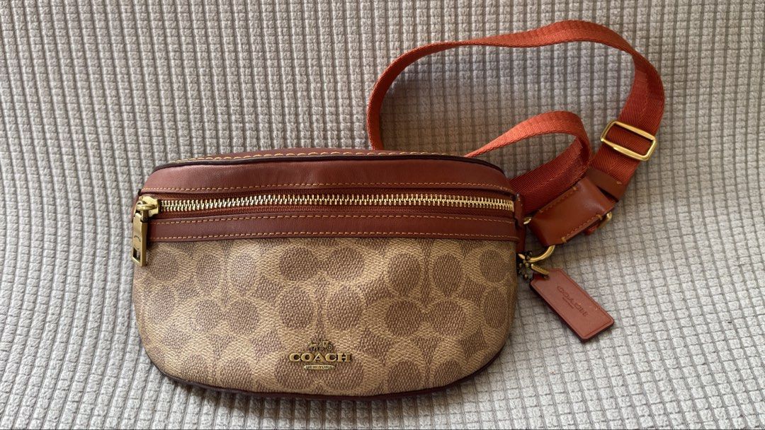 Coach Belt Bag (Category: Luxury Bags & Wallets) located in Manila. Submitted by xyrilleprix (Listing ID 1470632296, Image 1). Description: - Authentic Coach belt bag in brown signature canvas and smooth leather Bought in SG for SGD 325 - Front zip pocket and durable brass hardware with matching leather hangtag - Adjustable orange web strap with a secure buckle - Solid brown leather back side loc/meetup: Tagaytay.