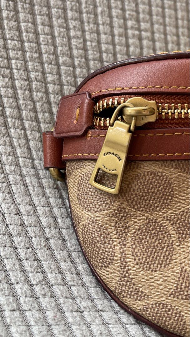 Coach Belt Bag (Category: Luxury Bags & Wallets) located in Manila. Submitted by xyrilleprix (Listing ID 1470632296, Image 3). Description: - Authentic Coach belt bag in brown signature canvas and smooth leather Bought in SG for SGD 325 - Front zip pocket and durable brass hardware with matching leather hangtag - Adjustable orange web strap with a secure buckle - Solid brown leather back side loc/meetup: Tagaytay.