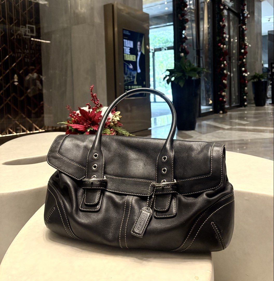 Coach Black Leather 9636 (Category: Luxury Bags & Wallets) located in Manila. Submitted by sophiaalex70506 (Listing ID 1470566331, Image 1). Description: - Brand: Coach - Material: Genuine black cowhide leather with contrast white stitching - Hardware: Silver-tone with dual buckle front flap closure - Straps: Double shoulder straps - Interior: Coach signature fabric lining with zippered pocket and creed patch - Extras: Original hangtag included -