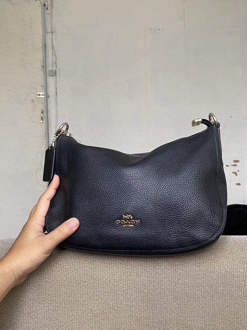Coach Black Leather Shoulder Bag (Category: Shoulder Bags) located in Calamba. Submitted by soleilcollections.ph (Listing ID 1470743001, Image 1). Description: Black pebbled leather Coach handbag. Gold-tone hardware with zipper closure. Flaw indicated in pictures, minimal fadings in hardware and not original hang tag. No scratch outside of the bag. .
