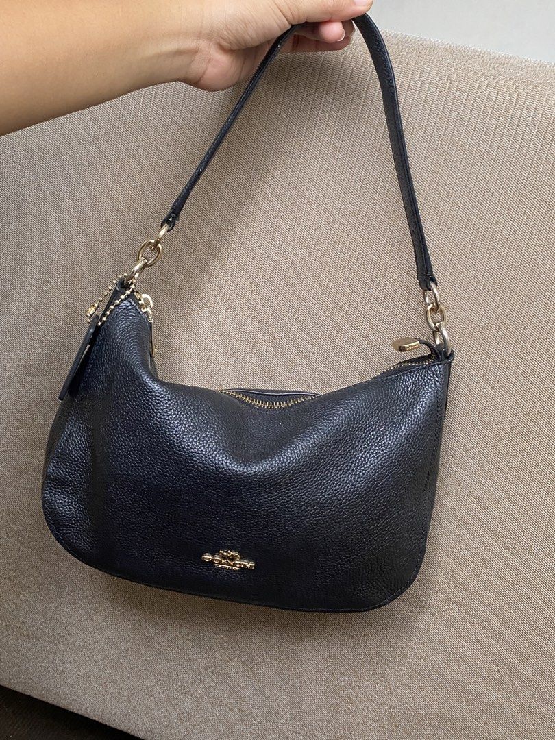 Coach Black Leather Shoulder Bag (Category: Shoulder Bags) located in Calamba. Submitted by soleilcollections.ph (Listing ID 1470743001, Image 2). Description: Black pebbled leather Coach handbag. Gold-tone hardware with zipper closure. Flaw indicated in pictures, minimal fadings in hardware and not original hang tag. No scratch outside of the bag. .